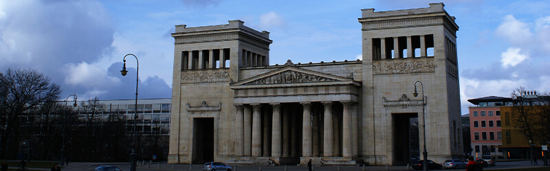 old building with columns and two towers